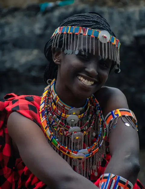 A smiling woman in beaded jewellery